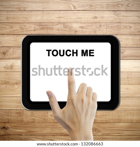 Blank tablet on brown wood plank wall texture background with hand touch
