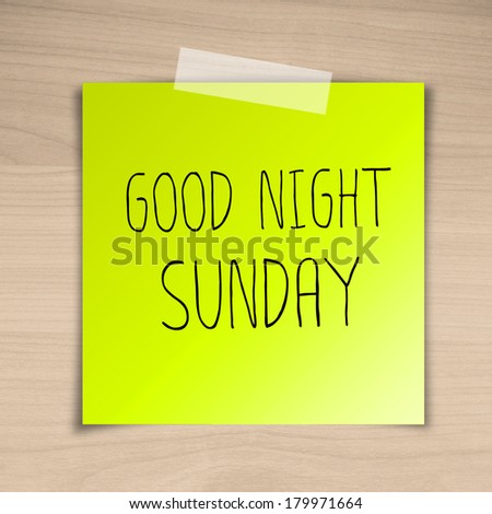 Good night sunday sticky paper on brown wood background texture