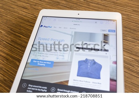 CHIANG MAI, THAILAND - SEPTEMBER 17, 2014: Paypal website displayed on Apple iPad Air tablet screen wood background. PayPal allows payments and money transfers to be made through the Internet.
