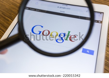 CHIANG MAI, THAILAND - SEPTEMBER 17, 2014: Magnifying glass of Google search page view on web browser Apple iPad Air device.