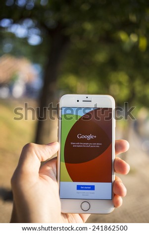 CHIANG MAI, THAILAND - JANUARY 04, 2015: Man hold Apple iphone 6 with Google+ social network of the Google company. Information of a social network, influences Google search results.