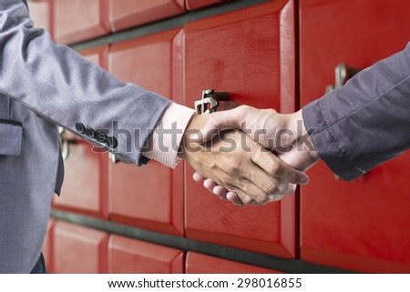 Business handshake on red china style background