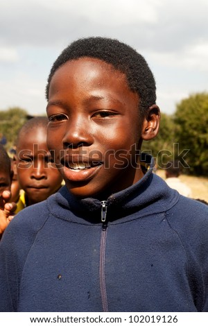 PIGGS PEAK, SWAZILAND-JULY 29: Unidentified Swazi schoolboy on July 29, 2008 in Nazarene Mission School, Piggs Peak, Swaziland. Close to 10% of SwazilandÃ¢Â?Â?s population are orphans, due to HIV/AIDS.