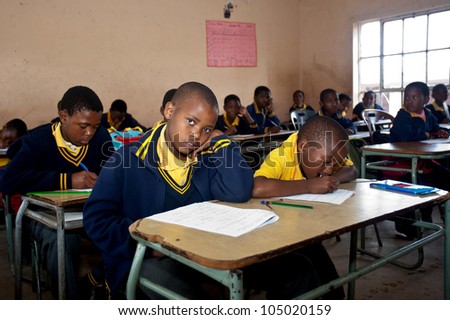 PIGGS PEAK, SWAZILAND-JULY 29: Unidentified orphan schoolboys on July 29, 2008 in Nazarene Mission School, Piggs Peak, Swaziland. Close to 10% of Swazilands population are orphans, due to HIV/AIDS.