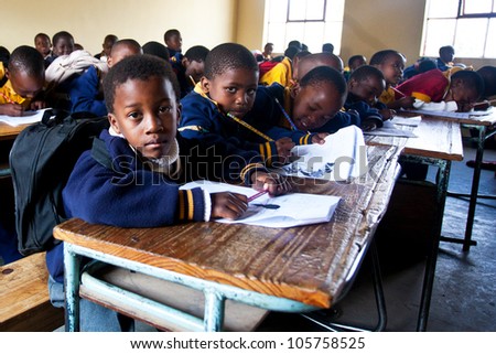 PIGGS PEAK, SWAZILAND-JULY 29: Unidentified orphan students on July 29, 2008 in Nazarene Mission School, Piggs Peak, Swaziland. Close to 10% of Swazilands population are orphans, due to HIV/AIDS.