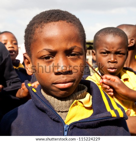 PIGGS PEAK, SWAZILAND-JULY 29: Unidentified orphan schoolboys on July 29, 2008 in Nazarene Mission School, Piggs Peak, Swaziland. Close to 10% of Swaziland\'s population are orphans, due to HIV/AIDS.