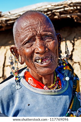 MAASAI MARA, KENYA - OCT 15: Portrait of an old Maasai woman on Oct 15, 2012 in the Maasai Mara, Kenya. Maasai are a Nilotic ethnic group of semi-nomadic people located in Kenya and Tanzania.