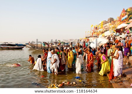 VARANASI, INDIA - APRIL 23: Unidentified people taking ritual bath in the river Ganga on April 23, 2011 in the holy city of Varanasi, India. The holy ritual bath is held every day.