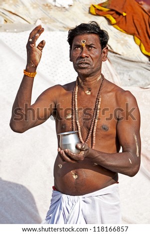 VARANASI, INDIA - APRIL 23: Unidentified hindu man meditates before taking ritual bath in the river Ganga on April 23, 2011 in the holy city of Varanasi, India. The holy ritual bath is held every day.