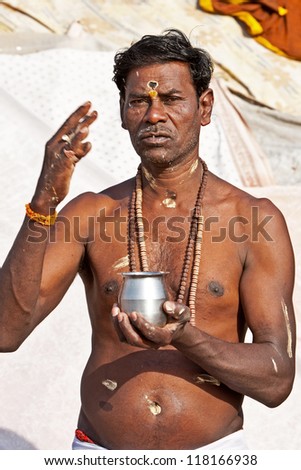 VARANASI, INDIA - APRIL 23: Unidentified hindu man meditates before taking ritual bath in the river Ganga on April 23, 2011 in the holy city of Varanasi, India. The holy ritual bath is held every day.