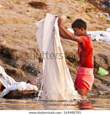 Varanasi, India - April 24: Unidentified Man Washes His Clothes In The River Ganga On April 24, 2011 In The Holy City Of Varanasi, India. The Holy Ritual Of Washing And Bathing Is Held Every Day.