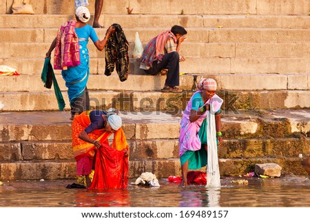 VARANASI, INDIA - APRIL 24: Unidentified people washing their clothes in the river Ganga on April 24, 2011 in the city of Varanasi, India. The holy ritual of washing and bathing is held every day.
