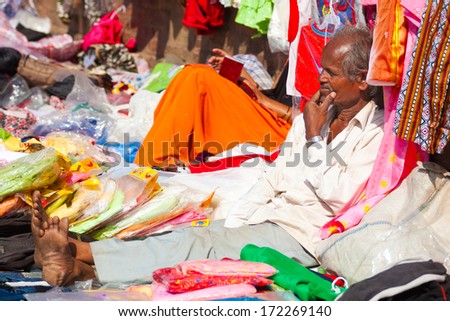 BHAKTAPUR, NEPAL - OCT 20: Unidentified Newari man selling clothes on the street on Oct 20, 2007 in Bhaktapur, Nepal. The Newars are the indigenous people of the Kathmandu Valley in Nepal.