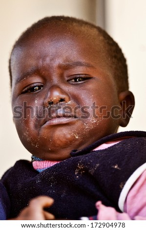 MBABANE, SWAZILAND - AUGUST 5: Portrait of unidentified orphan Swazi boy on August 5, 2008 in Mbabane, Swaziland. Close to 10 percent of Swaziland's total population are orphans, due to HIV/AIDS.