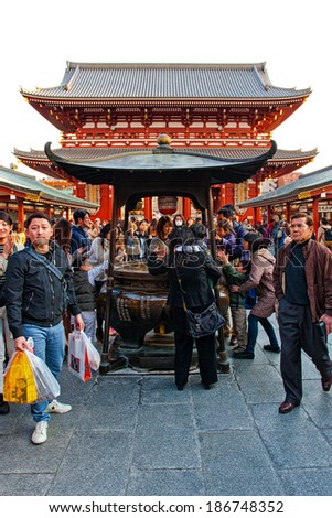 TOKYO, JAPAN - MARCH 23: Unidentified tourists at the Senso-ji Temple on March 23, 2014 in Tokyo,  Japan.The Senso-ji Temple is the symbol of Asakusa and one of the most famous temples in Japan.