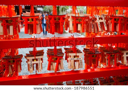 KYOTO, JAPAN - MARCH 27: Small praying torii cards at the Fushimi Inari Shrine in Kyoto, Japan on March 27, 2014. There are 1,600 Buddhist temples scattered throughout the prefecture of Kyoto.