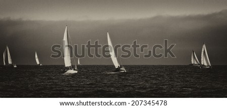 Vintage style black and white image of sailboats on the Pacific ocean; Santa Cruz, California, USA