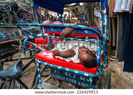 DELHI - APR 16: Indian rickshaw rider sleeping on his rickshaw on April 16, 2011 in Delhi, India. Delhi is the largest urban agglomeration in India, and the 4th most populous city on the planet.