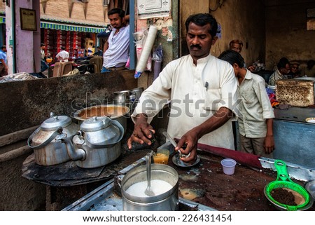 DELHI - APR 16: Unidentified Indian man preparing tea on April 16, 2011 in Delhi, India. Delhi is the largest urban agglomeration in India, and the 4th most populous city on the planet.