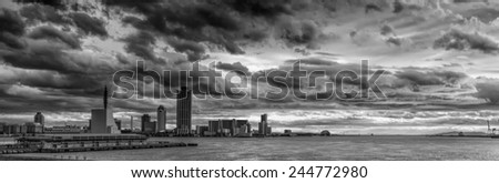 Vintage style black and white image of the stormy sky above the Port of Osaka in Japan. The Port of Osaka is the main port in Japan, located in Osaka within Osaka Bay.