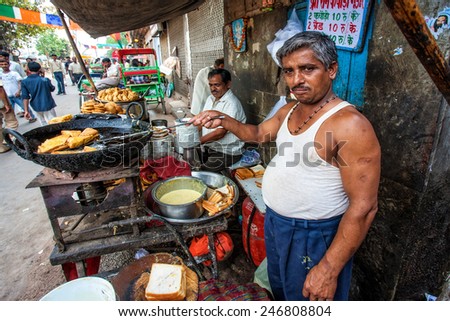 DELHI - APR 16: Unidentified market vendor selling food on the street on April 16, 2011 in Delhi, India. Street foods in India are reasonably priced and easily available.