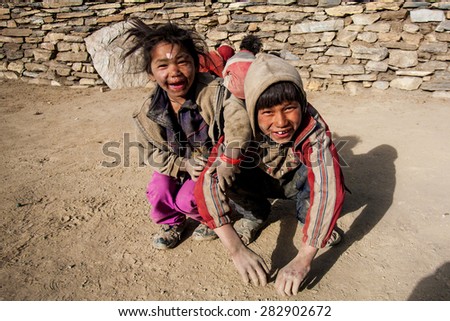 NAR, NEPAL - OCTOBER 31: Unidentified Tibetan children on the famous Annapurna trail on October 31, 2008, in Nar village, Nepal. The majority of the local population are Tibetans.