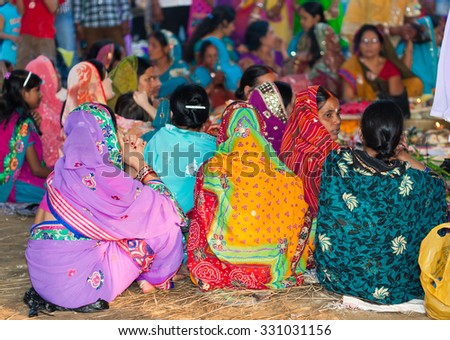 RAXAUL, INDIA - NOV 8: Unidentified Indian women at the Hindu Chhath festival offering prashad (prayer offerings) to the setting sun on Nov 8, 2013 in Raxaul, Bihar state, India.