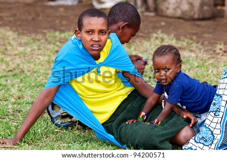 MAASAI MARA, KENYA-AUG 18: Unidentified Maasai children on Aug 18, 2011 in Maasai Mara, Kenya. Maasai are a Nilotic ethnic group of semi-nomadic people located in Kenya and northern Tanzania.