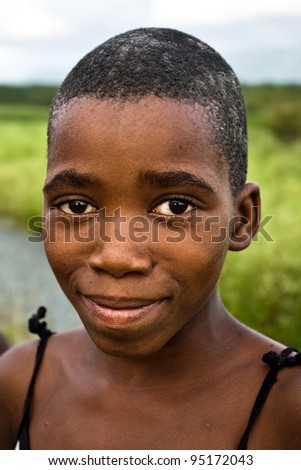MANZINI, SWAZILAND-DEC 27: Portrait of unidentified Swazi girl on Dec 27, 2007 in a small village near Manzini, Swaziland.  Close to 10 percent of Swaziland’s total population are orphans, due to HIV/AIDS.