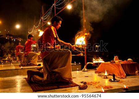 VARANASI, INDIA - APRIL 23: An unidentified Hindu priest performs religious Ganga Aarti ritual (fire puja) at Dashashwamedh Ghat on April 23, 2011 in Varanasi, Uttar Pradesh, Central India
