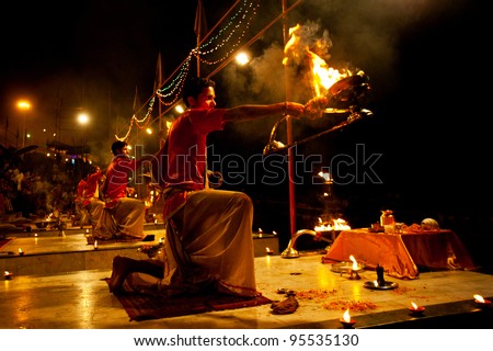 VARANASI, INDIA - APRIL 23: An unidentified Hindu priest performs religious Ganga Aarti ritual (fire puja) at Dashashwamedh Ghat on April 23, 2011 in Varanasi, Uttar Pradesh, Central India