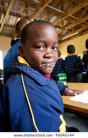 PIGGS PEAK, SWAZILAND-JULY 29: Unidentified Swazi schoolboy on July 29, 2008 in Nazarene Mission School, Piggs Peak, Swaziland. Close to 10% of Swaziland’s population are orphans, due to HIV/AIDS.