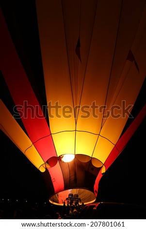 The glow of a hot air balloon at night