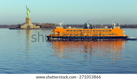 NEW YORK, USA, APRIL 19, 2015: Early morning sunlight reflecting off the Staten Island Ferry, a free ferry service between St. George on Staten Island and Whitehall Street in lower Manhattan