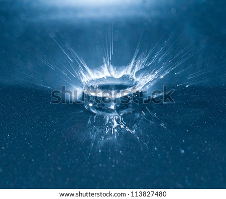 photograph of a water droplet and the hitting point on a base causing an electric abstractly