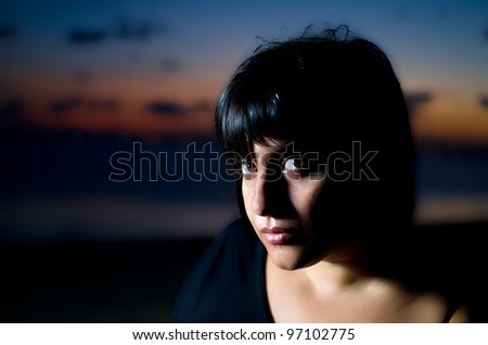 Photographic portrait of a young woman in the dusk of a summer afternoon on the beach in Murcia (Spain)