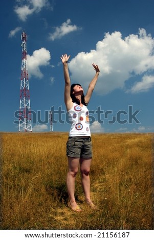 Young cute female on field raising hands to the sky
