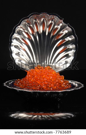 Red caviar on a black background