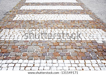 white stripes across the street - Pedestrian crossing made of cobblestones