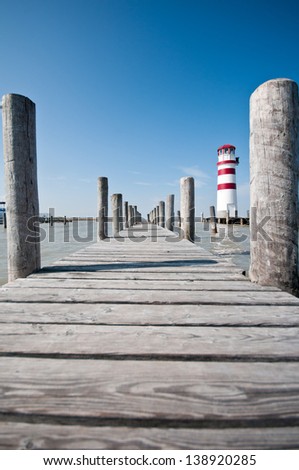 wooden bridge and lighthouse against the deep blue sky in Burgenland Neusiedlersee