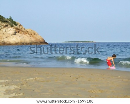 Boy Plays in the Water at the Beach