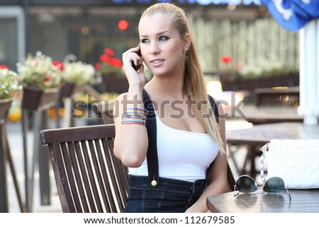 woman speaks by mobile phone in the street