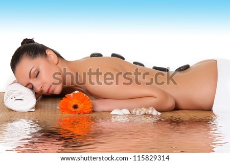 Girl on a stone therapy, hot stone massage.