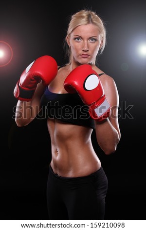beautiful young woman wearing a pair of boxing gloves