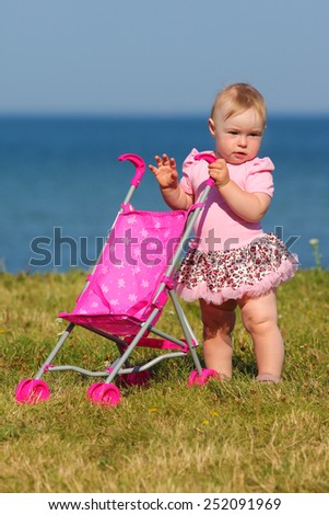 small child walks by the sea