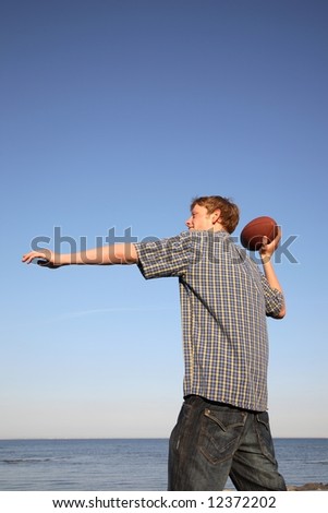 Teenage boy ready to throw an American football