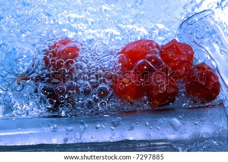 red fruits in water drops and bubbles