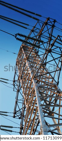 Transfer electric power on distance. Power transmission lines and tower on blue sky background