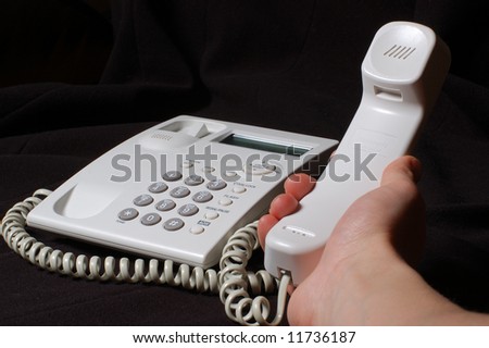 White business telephone on hand.English buttons