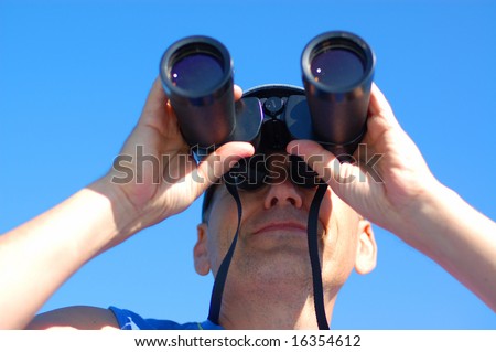 Business vision - man with the binoculars over blue sky
